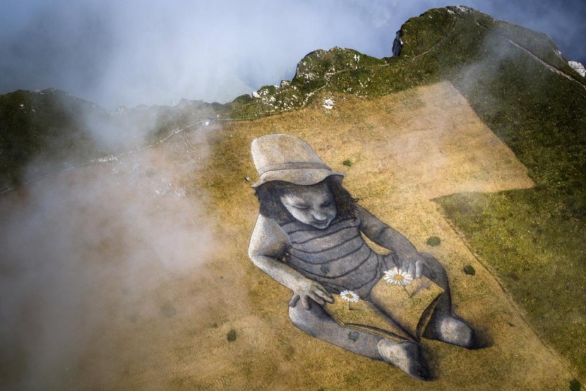 فنان يرسم لوحة عملاقة بعنوان "قصة المستقبل" على جبل سويسري